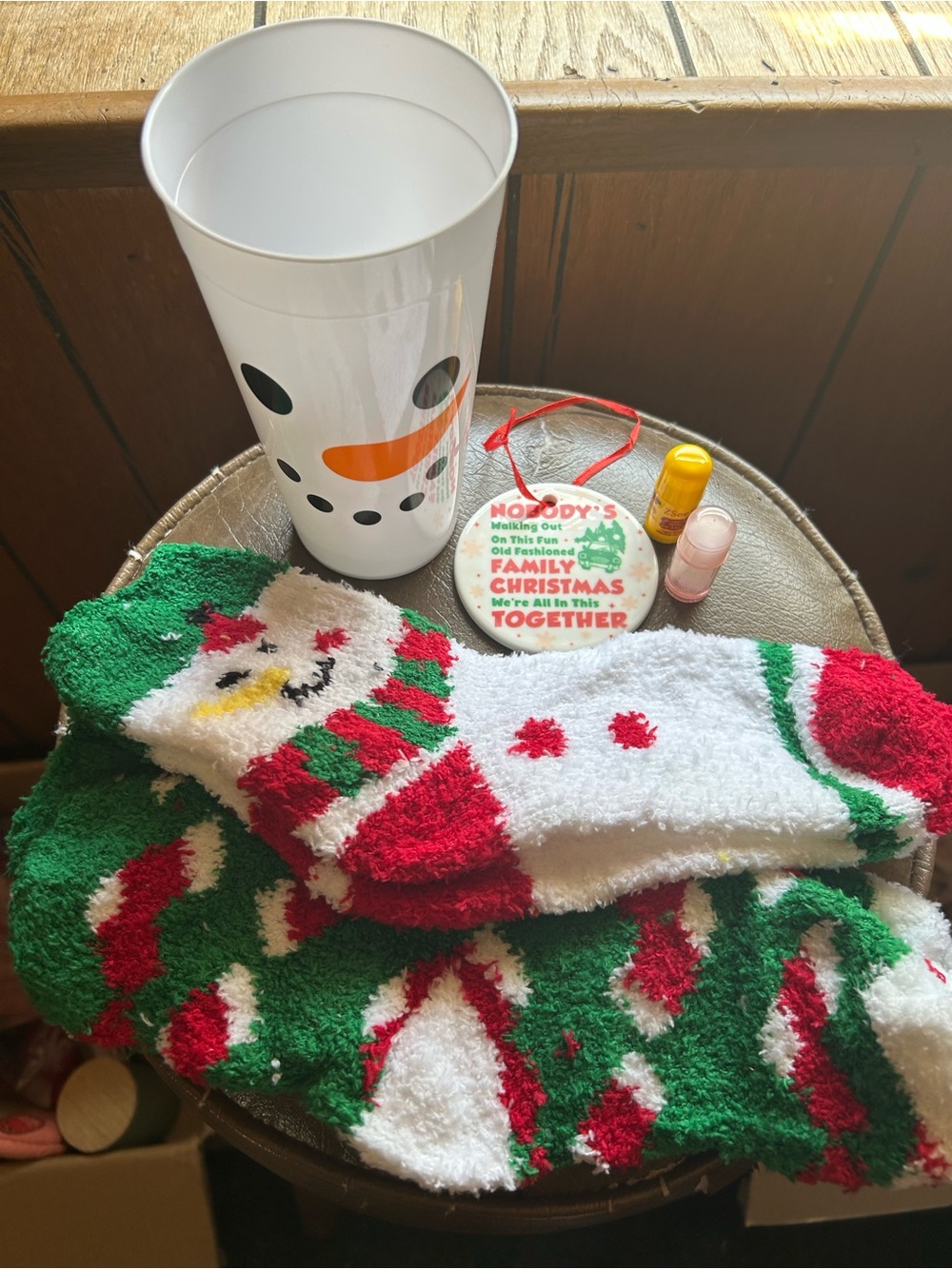 16oz Snowman Cup, 2 pairs of Fuzzy Socks, 2 Lip Balms and Christmas Ornament